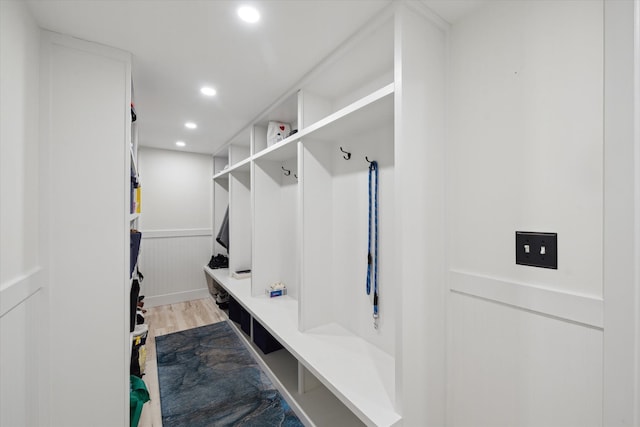 mudroom with recessed lighting, wood finished floors, and wainscoting