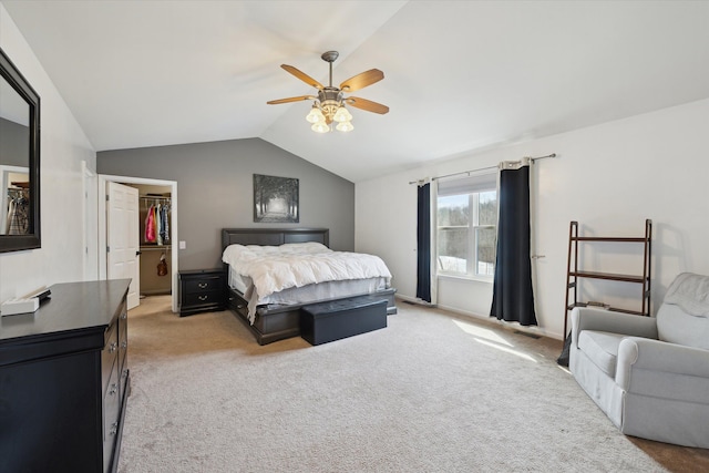 bedroom with lofted ceiling, ceiling fan, a spacious closet, a closet, and light carpet