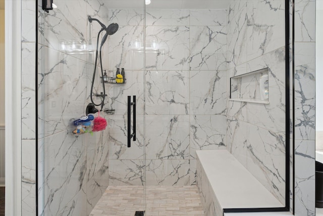 full bathroom featuring a marble finish shower