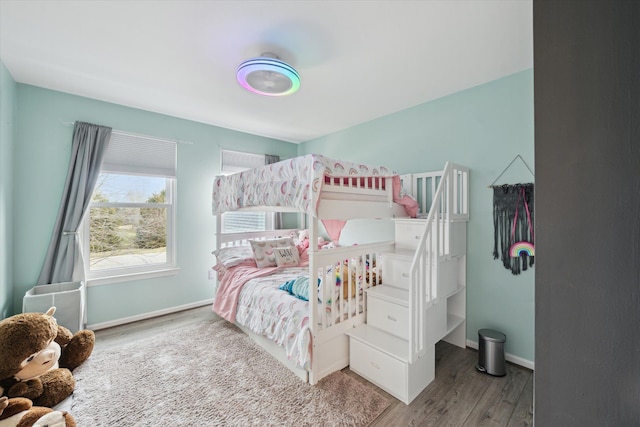 bedroom with baseboards and wood finished floors