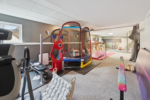 playroom featuring carpet and a paneled ceiling