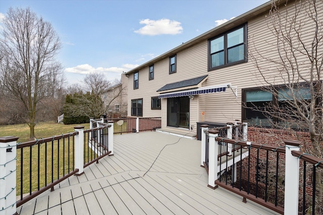 wooden deck featuring a yard