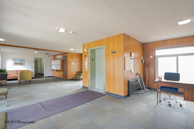 carpeted office space with wooden walls