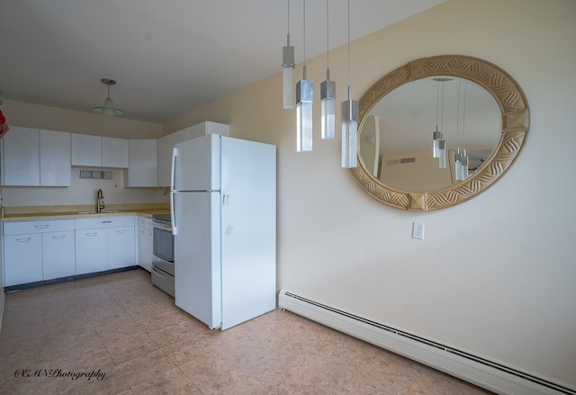 kitchen featuring freestanding refrigerator, stainless steel electric range, light countertops, a baseboard heating unit, and a sink