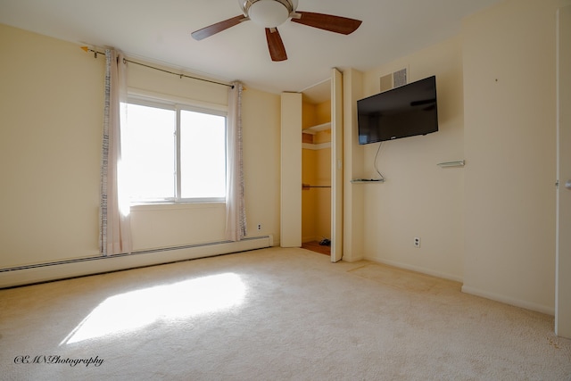 unfurnished bedroom with a baseboard radiator, carpet flooring, visible vents, baseboards, and a ceiling fan