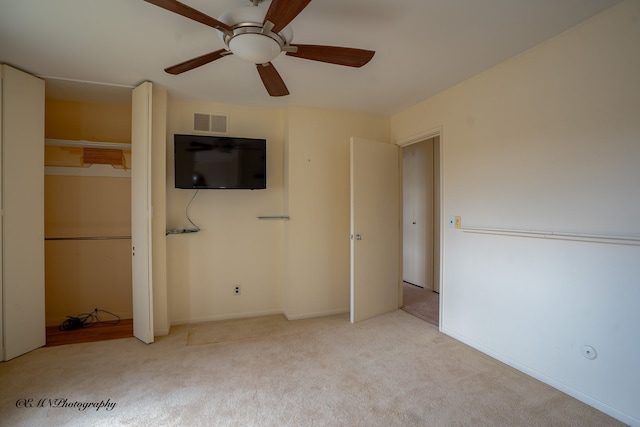 unfurnished bedroom with ceiling fan, carpet, visible vents, and baseboards