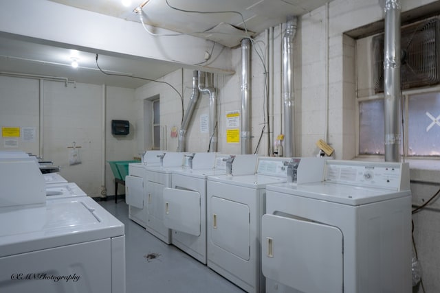 clothes washing area featuring washing machine and dryer and laundry area