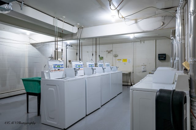 shared laundry area with a baseboard heating unit and washer and clothes dryer