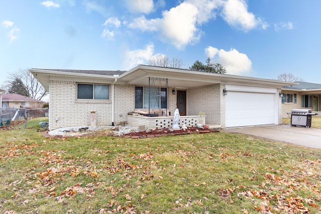 ranch-style house featuring driveway, an attached garage, fence, a front lawn, and brick siding