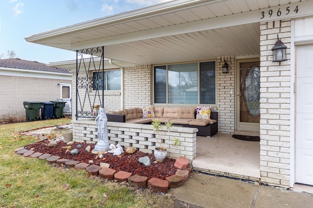 view of patio / terrace with a garage, a porch, and outdoor lounge area