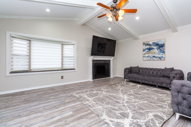 living room featuring baseboards, ceiling fan, wood finished floors, vaulted ceiling with beams, and a fireplace