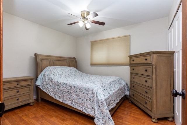 bedroom with ceiling fan, a closet, and light wood-type flooring