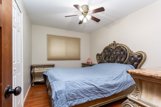 bedroom featuring a ceiling fan, dark wood finished floors, and baseboards