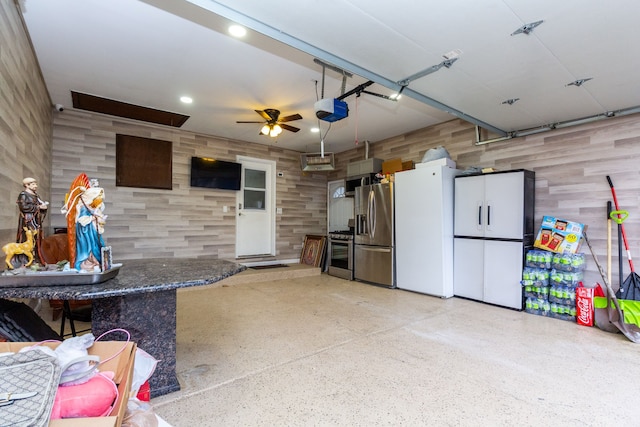 garage featuring recessed lighting, stainless steel fridge, a ceiling fan, and a garage door opener