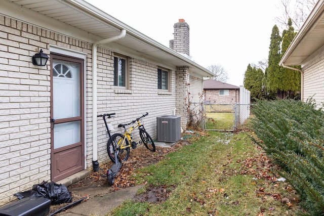 view of yard featuring central AC unit and fence