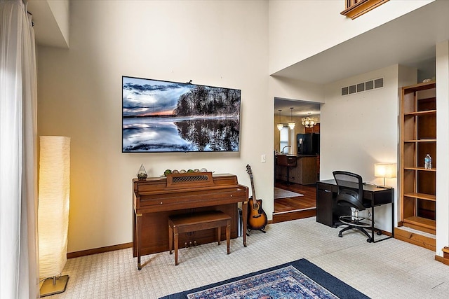 office area featuring visible vents, carpet flooring, and baseboards