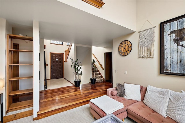 living room with wood finished floors and stairs