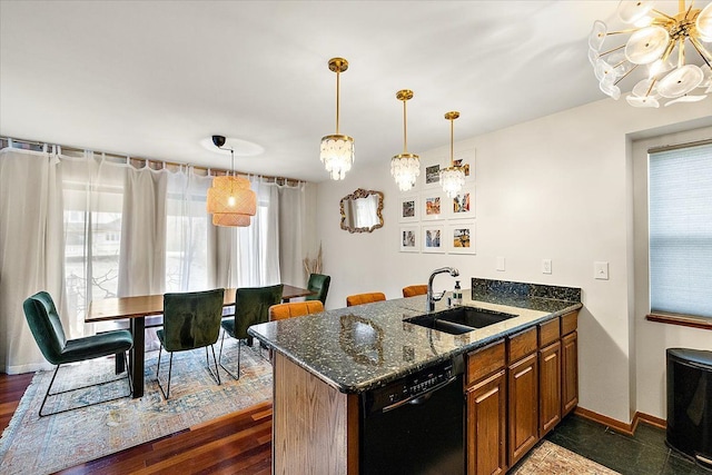 kitchen with plenty of natural light, brown cabinets, black dishwasher, and a sink