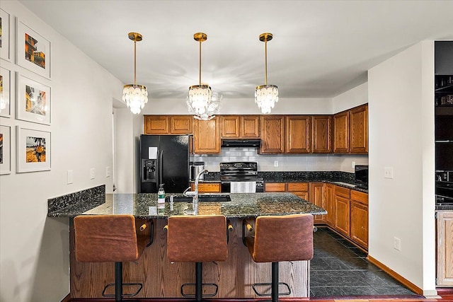 kitchen with brown cabinetry, a sink, black fridge with ice dispenser, range with electric stovetop, and tasteful backsplash