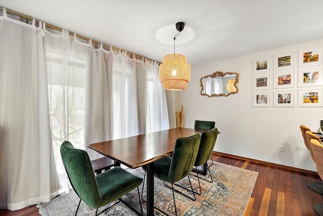 dining room with dark wood finished floors and baseboards