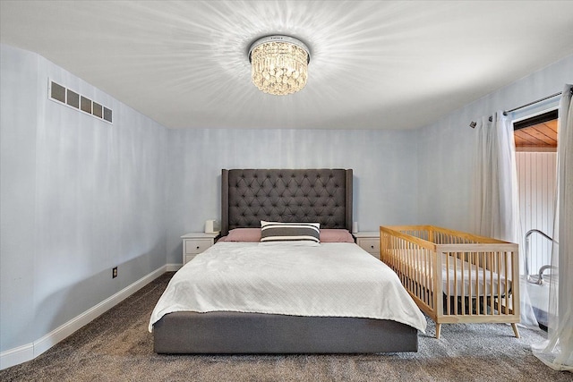 carpeted bedroom featuring visible vents, baseboards, multiple windows, and an inviting chandelier