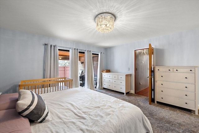 carpeted bedroom with a chandelier