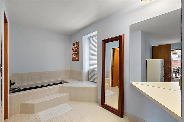 bathroom with a bath and tile patterned flooring