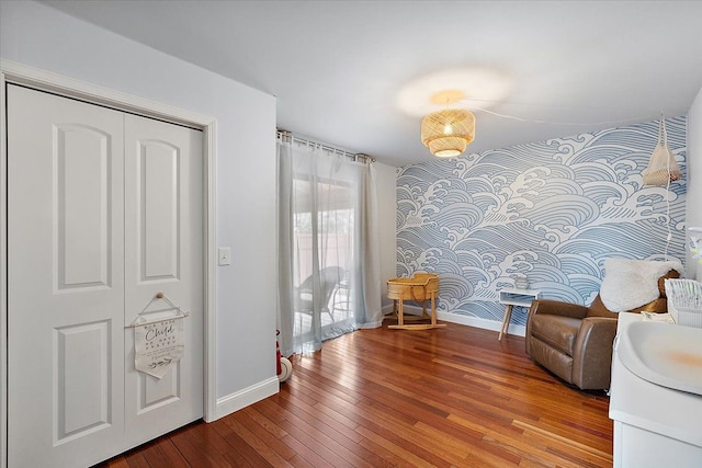 sitting room featuring baseboards and hardwood / wood-style flooring