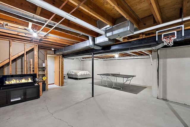 unfinished basement featuring a fireplace