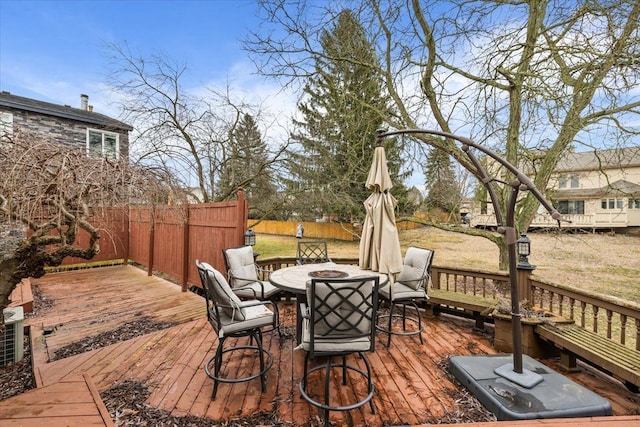 wooden terrace featuring an outdoor fire pit and fence