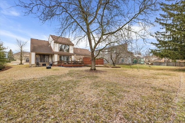 view of yard featuring a wooden deck and fence