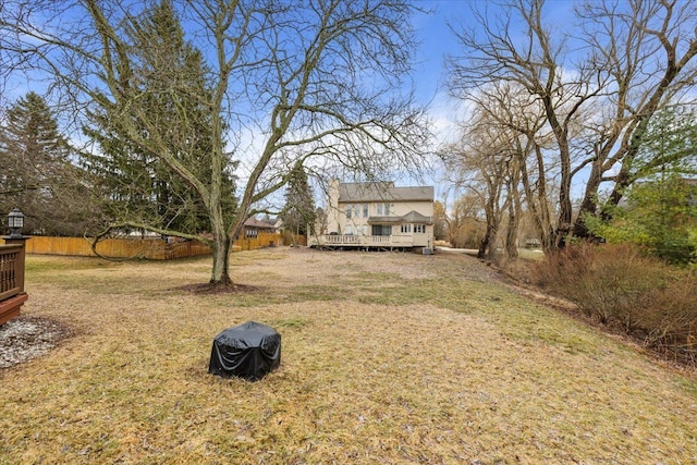 view of yard with a deck and fence