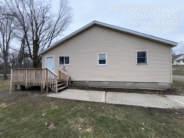 rear view of property with a wooden deck