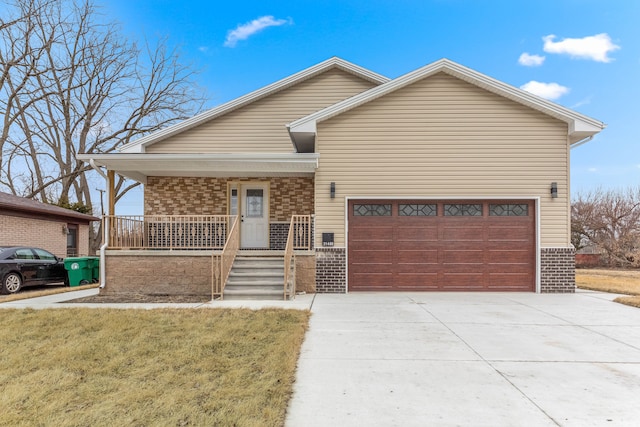 single story home with a garage, driveway, a porch, and brick siding