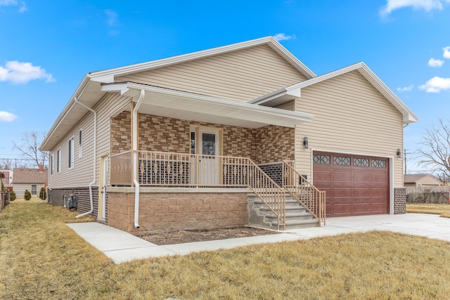 view of front of home with a garage, a front yard, covered porch, and driveway