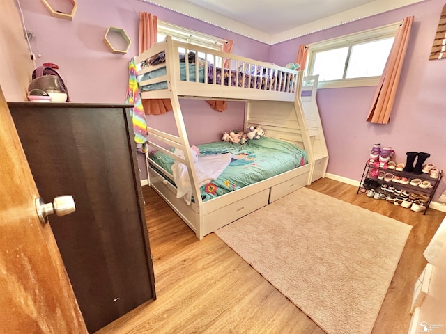 bedroom featuring baseboards and wood finished floors