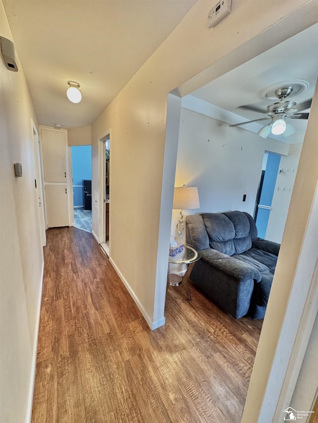 hallway with wood finished floors and baseboards