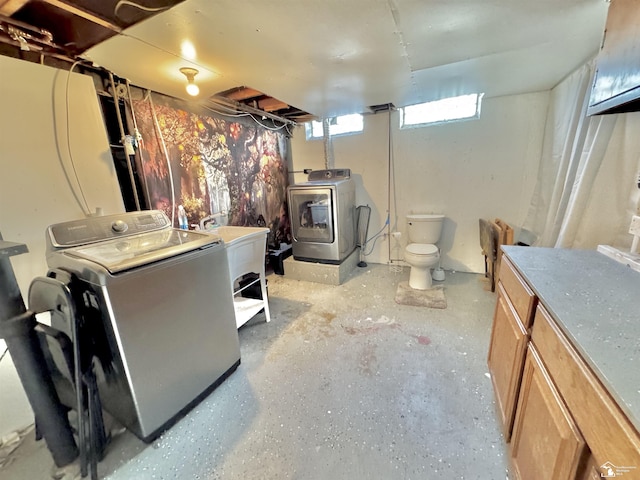 basement featuring washer and clothes dryer and a sink