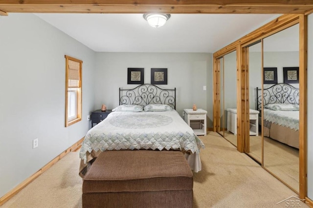 bedroom featuring light carpet and baseboards