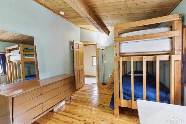 unfurnished bedroom featuring hardwood / wood-style flooring, wood ceiling, and beamed ceiling