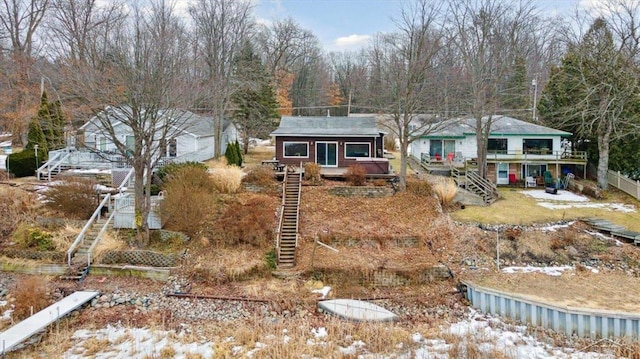 view of front of home with stairs, fence, and a wooden deck