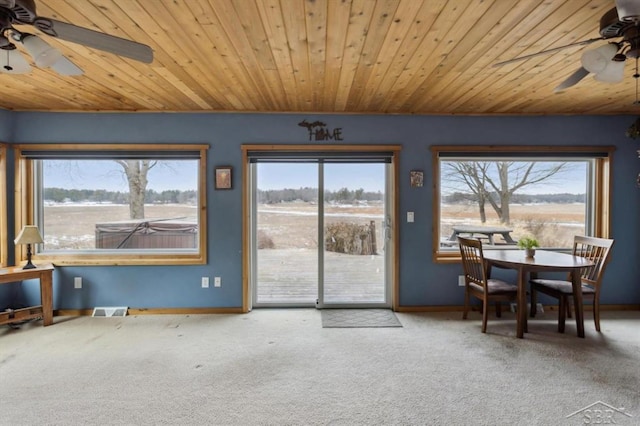 entryway featuring a ceiling fan, visible vents, plenty of natural light, and carpet floors