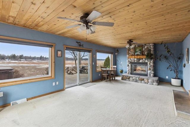 unfurnished living room with carpet floors, wooden ceiling, a fireplace, and visible vents