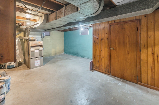 unfinished basement with concrete block wall