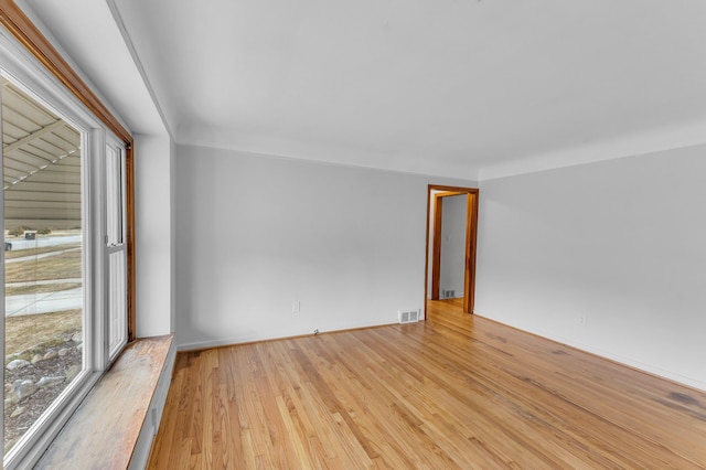 spare room with visible vents and hardwood / wood-style flooring