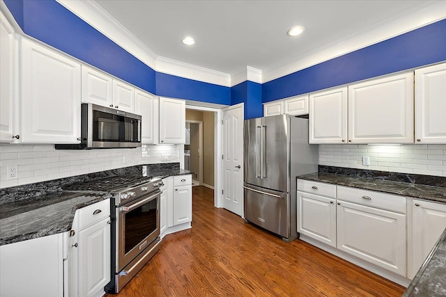 kitchen featuring white cabinetry, dark wood-type flooring, high end appliances, and crown molding