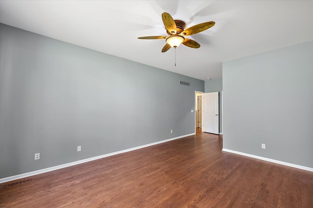 empty room featuring baseboards, wood finished floors, visible vents, and ceiling fan