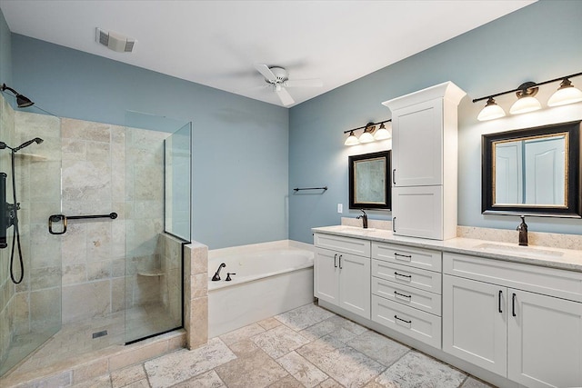 bathroom featuring a sink, ceiling fan, a shower stall, and a bath