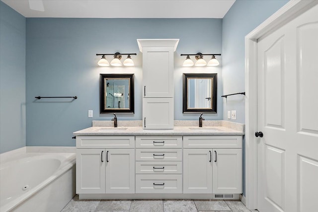 bathroom featuring double vanity, visible vents, a garden tub, and a sink