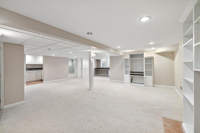 below grade area featuring recessed lighting, baseboards, and light carpet